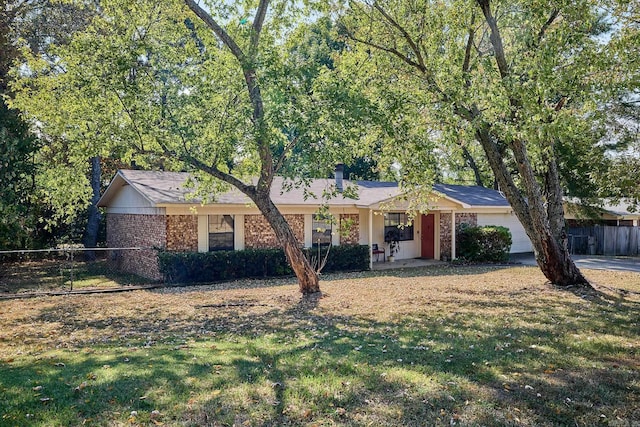 single story home featuring a garage and a front lawn