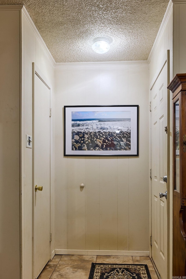 entryway with crown molding and a textured ceiling