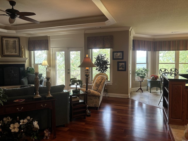 22 Alta Way, Hot Springs Village, AR 71909 - living room featuring ornamental molding, ceiling fan, baseboards, wood-type flooring, and a glass covered fireplace