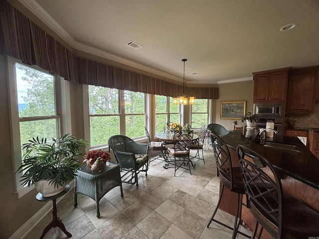 22 Alta Way, Hot Springs Village, AR 71909 - kitchen featuring appliances with stainless steel finishes, a sink, dark countertops, light stone finish flooring, and ornamental molding
