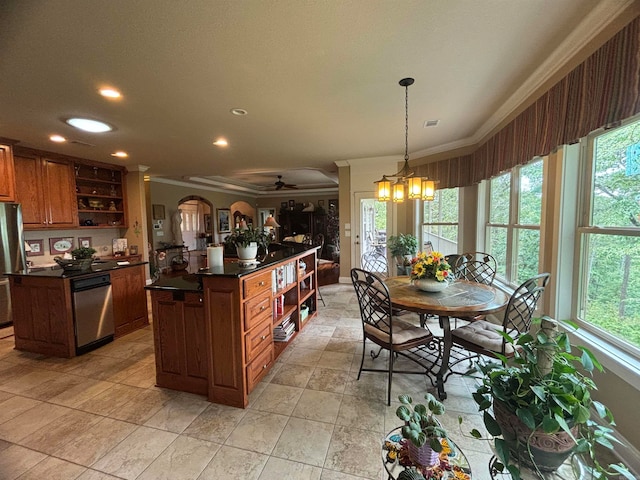 kitchen featuring decorative light fixtures, stainless steel appliances, and a wealth of natural light