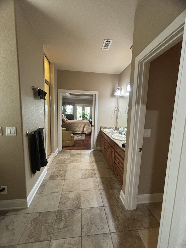22 Alta Way, Hot Springs Village, AR 71909 - bathroom featuring baseboards, double vanity, and connected bathroom