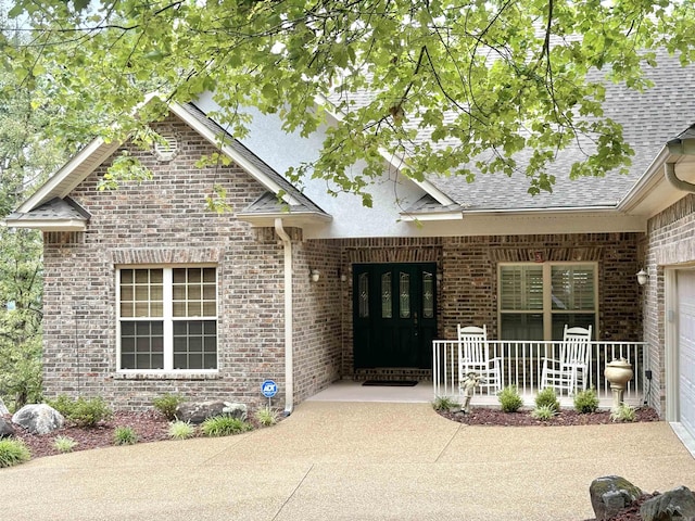 22 Alta Way, Hot Springs Village, AR 71909 - view of exterior entry featuring brick siding, a shingled roof, and covered porch
