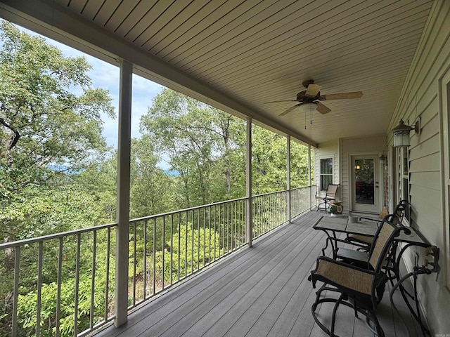 wooden terrace featuring ceiling fan