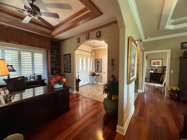 office featuring ceiling fan, crown molding, a tray ceiling, and dark hardwood / wood-style floors