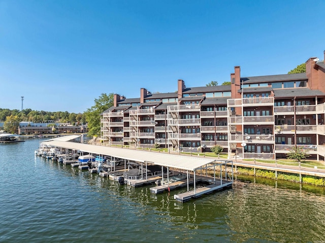 view of dock featuring a water view and a balcony