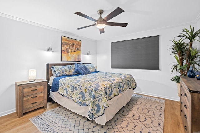 bedroom with ornamental molding, ceiling fan, and light hardwood / wood-style floors