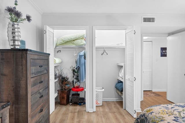 bedroom featuring crown molding and light hardwood / wood-style flooring