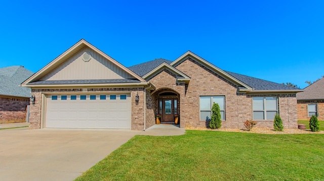 view of front facade with a garage and a front lawn