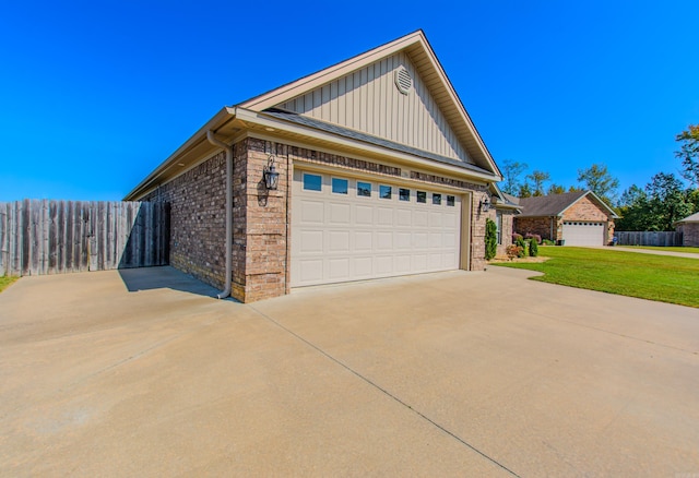 view of side of home with a garage and a lawn