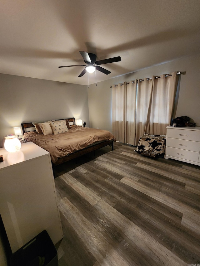 bedroom featuring ceiling fan and dark hardwood / wood-style floors