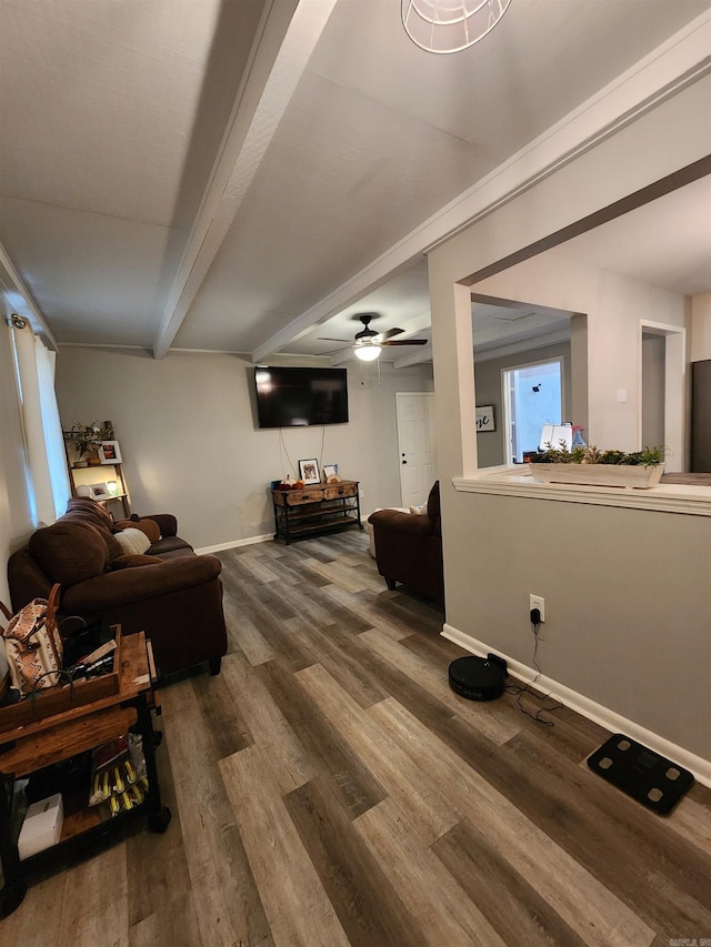 living room featuring ceiling fan, beamed ceiling, and hardwood / wood-style flooring