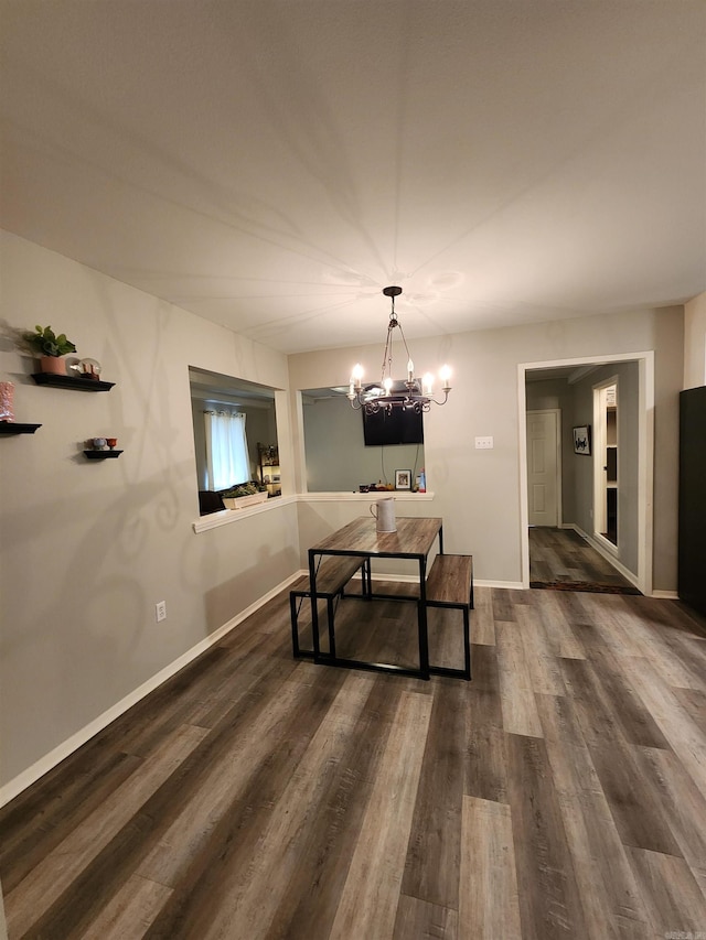 dining room featuring a notable chandelier and dark hardwood / wood-style floors