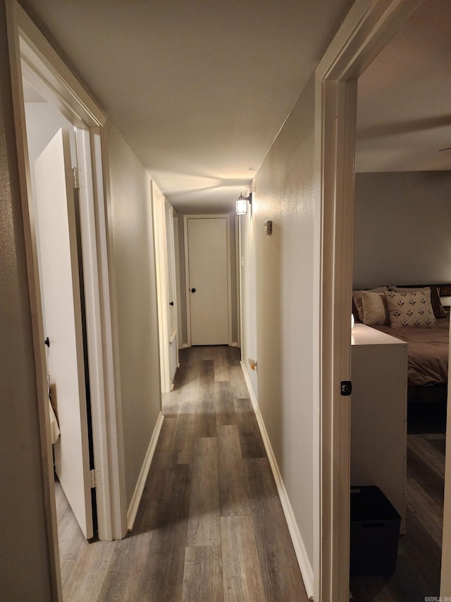 hallway with hardwood / wood-style floors