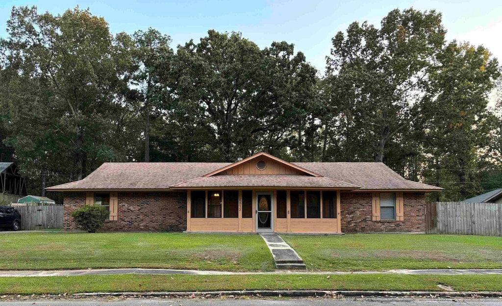 ranch-style house with a front lawn