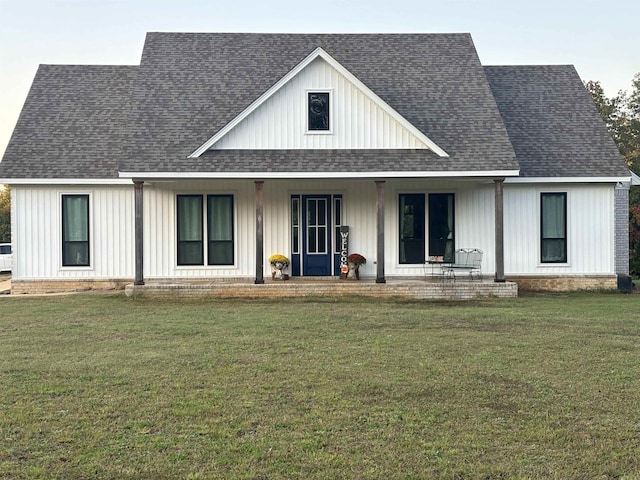 444 W Pleasant Springs Rd, Quitman, AR 72131 - view of front of house with board and batten siding, a shingled roof, a front yard, and covered porch