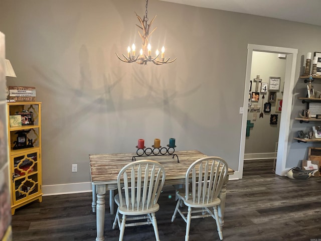 dining space featuring dark hardwood / wood-style floors and a chandelier