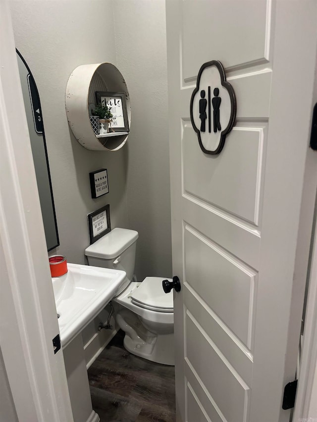 bathroom featuring hardwood / wood-style flooring and toilet