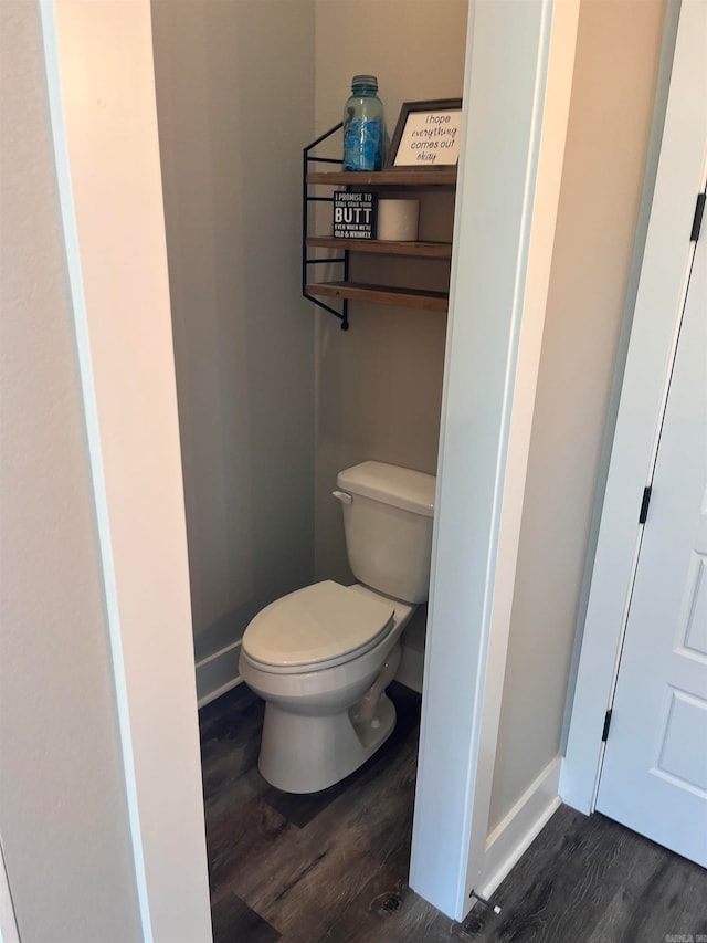 bathroom featuring toilet and wood-type flooring