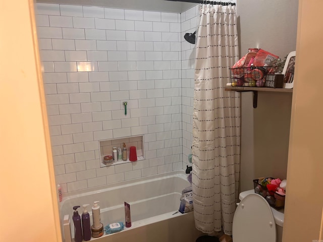 bathroom with shower / bath combo with shower curtain and toilet