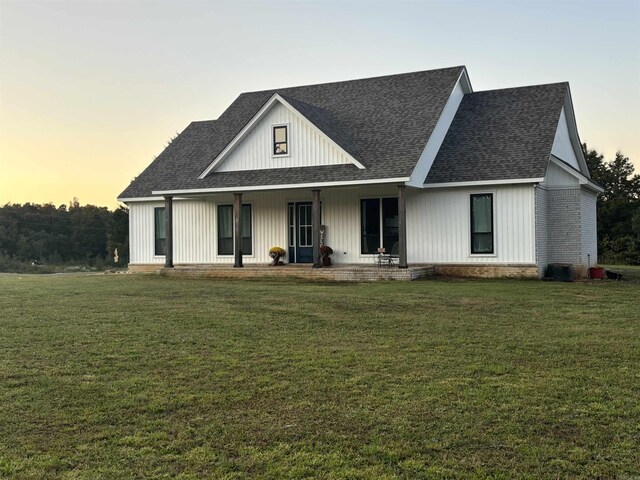 444 W Pleasant Springs Rd, Quitman, AR 72131 - view of front of home featuring roof with shingles, covered porch, and a lawn