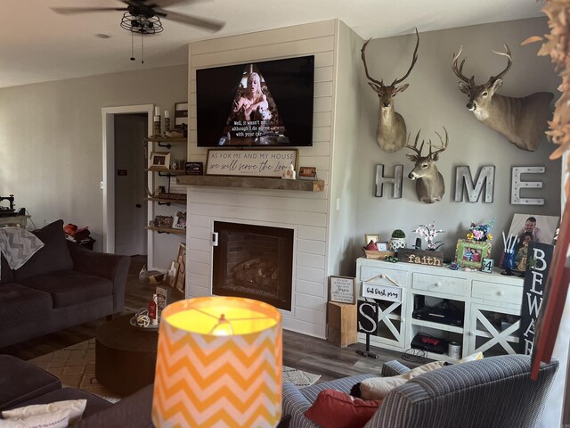 444 W Pleasant Springs Rd, Quitman, AR 72131 - living room with a fireplace, wood finished floors, and a ceiling fan
