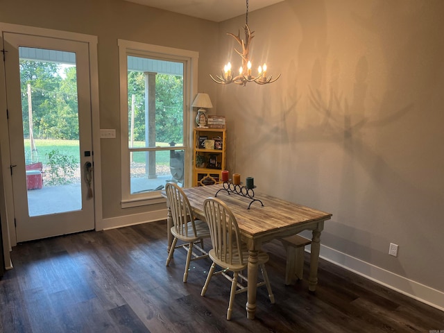 dining area featuring an inviting chandelier and dark wood-type flooring