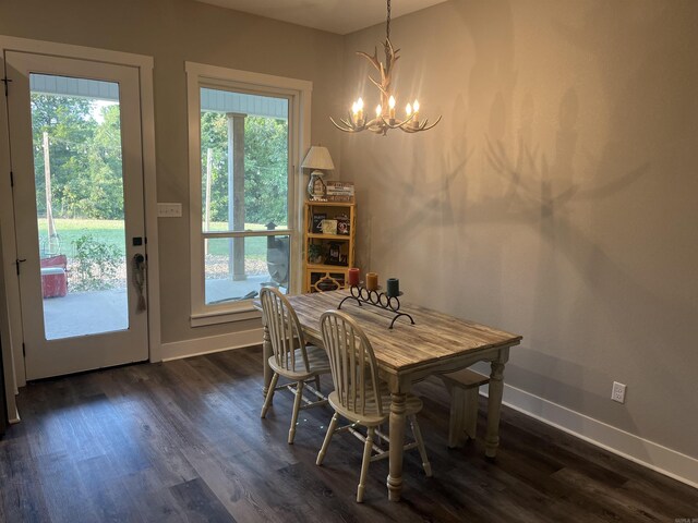 444 W Pleasant Springs Rd, Quitman, AR 72131 - dining area featuring dark wood finished floors, baseboards, and a notable chandelier