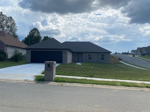 view of front of property with a front yard and a garage