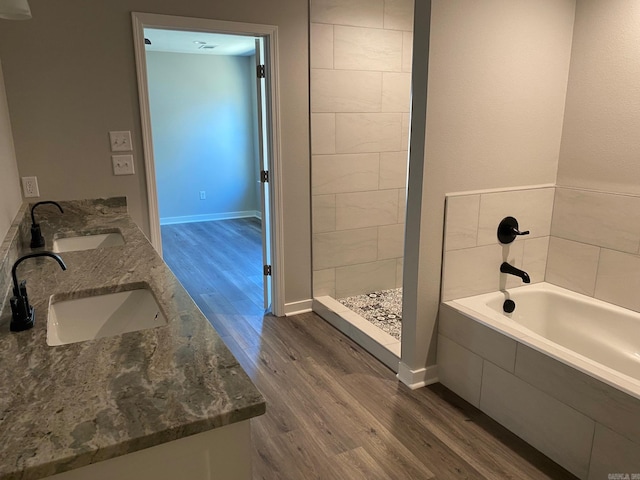 bathroom featuring hardwood / wood-style flooring, separate shower and tub, and vanity