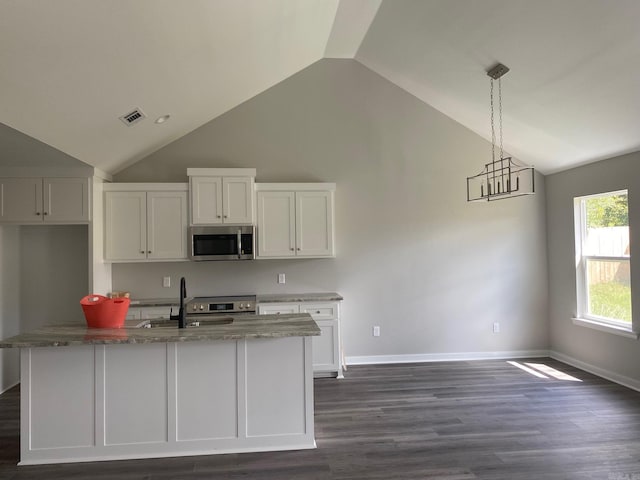 kitchen featuring white cabinets, pendant lighting, sink, a kitchen island with sink, and dark hardwood / wood-style flooring