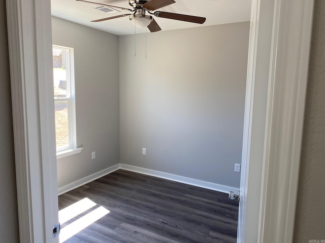 unfurnished room with dark hardwood / wood-style flooring and ceiling fan