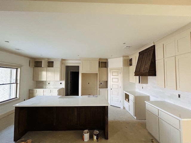 kitchen featuring white cabinetry, a spacious island, and decorative backsplash