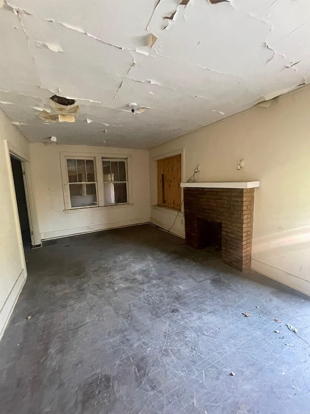 unfurnished living room with a brick fireplace