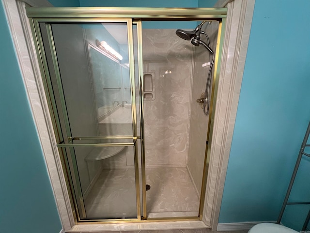 bathroom with a shower with door