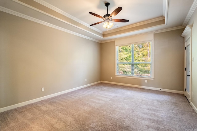 unfurnished room featuring ornamental molding, light carpet, ceiling fan, and a raised ceiling