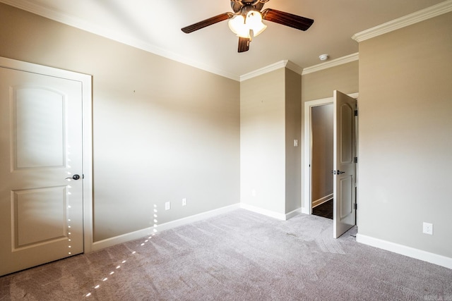 unfurnished bedroom featuring ceiling fan, crown molding, and light carpet