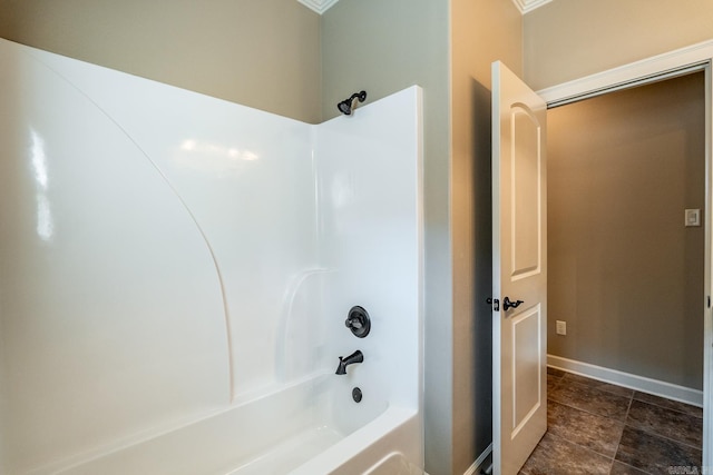 bathroom featuring crown molding and washtub / shower combination