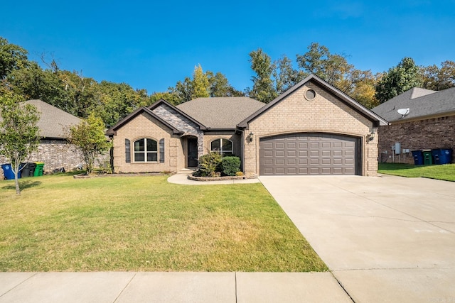 view of front of home with a garage and a front lawn