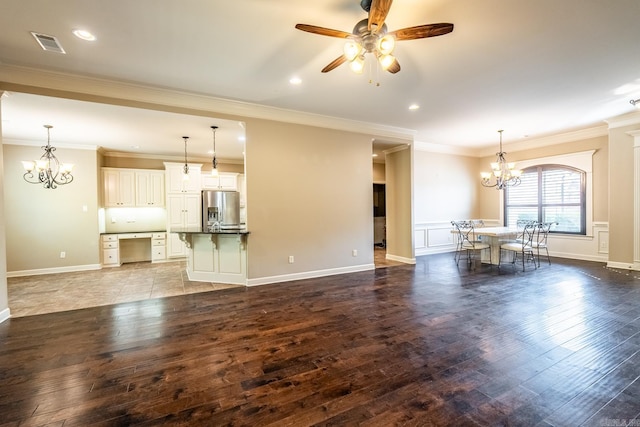 unfurnished living room with ornamental molding, ceiling fan, and dark wood-type flooring