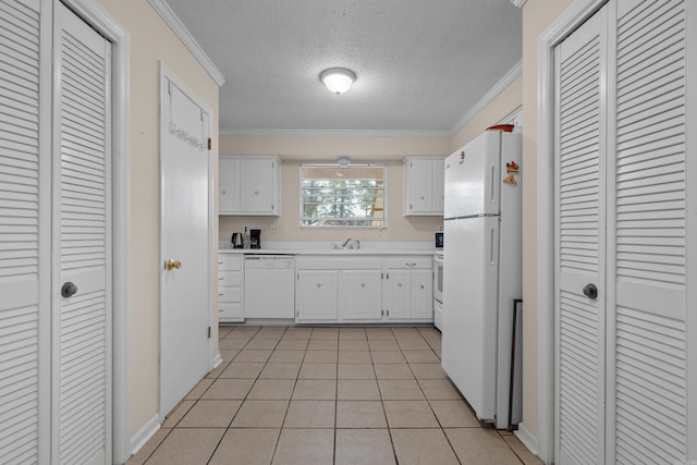 kitchen with crown molding, light tile patterned floors, white appliances, and white cabinetry