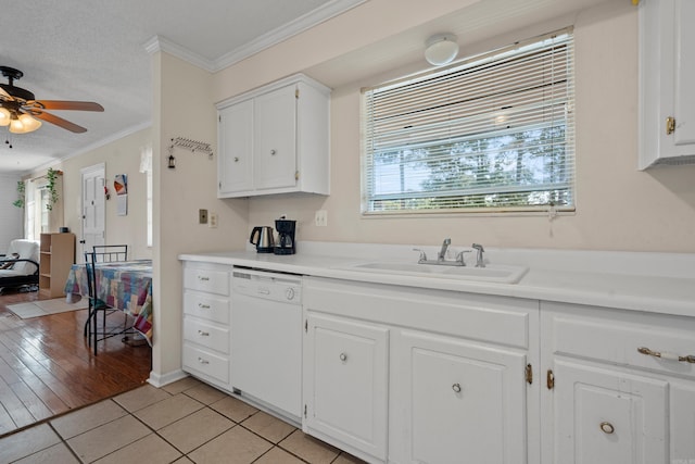 kitchen with white cabinets, sink, light hardwood / wood-style flooring, ornamental molding, and dishwasher