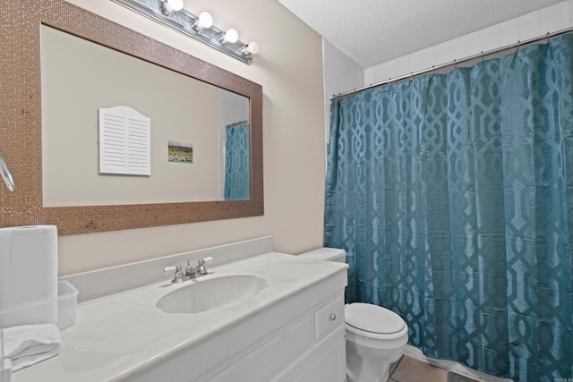 bathroom with a textured ceiling, walk in shower, vanity, and toilet