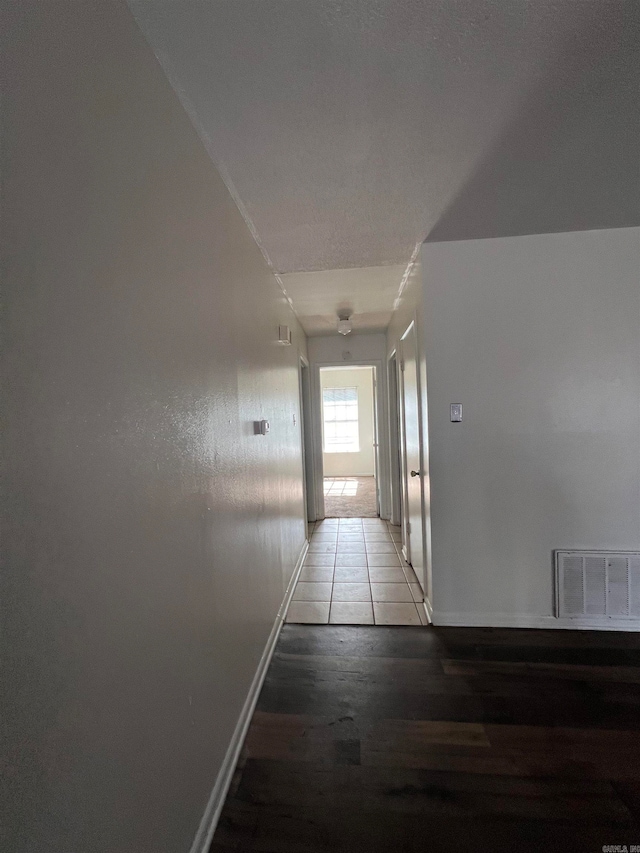 corridor with wood-type flooring