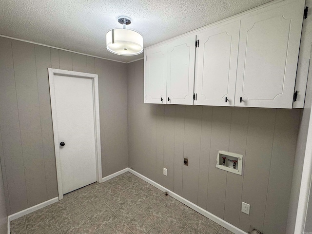 clothes washing area with washer hookup, cabinets, hookup for an electric dryer, wooden walls, and a textured ceiling