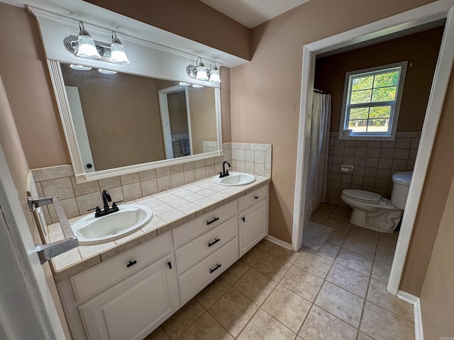 bathroom featuring vanity, tile walls, tile patterned flooring, and toilet