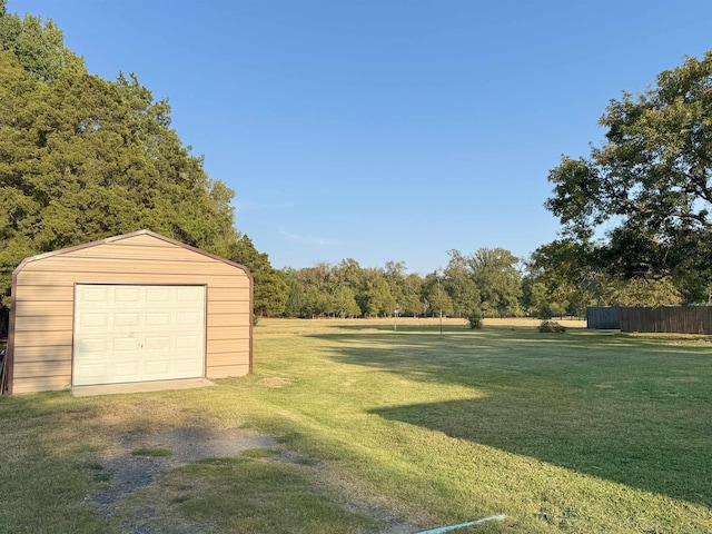 view of yard featuring a garage and an outdoor structure