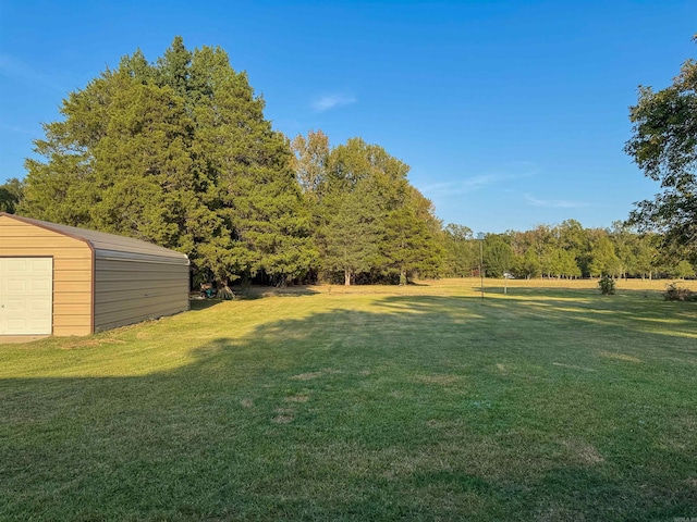 view of yard with a garage and an outdoor structure