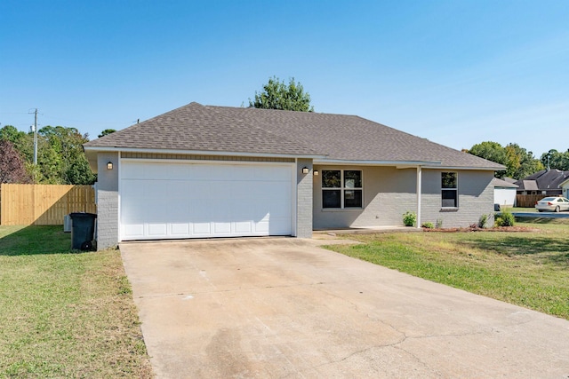 single story home featuring a front lawn and a garage