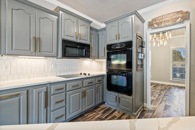 kitchen with black appliances, tasteful backsplash, dark hardwood / wood-style flooring, ornamental molding, and a textured ceiling